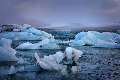 High angle view of ice formations in sea against sky