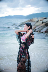 Young woman standing in sea