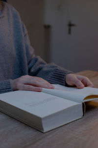 Midsection of man working on table