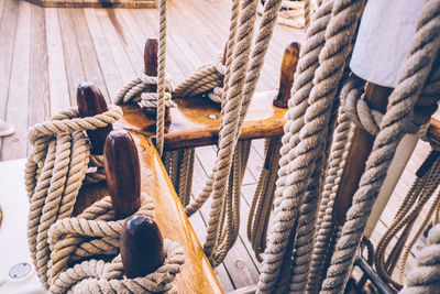 Close-up of rope tied to wood on boat deck