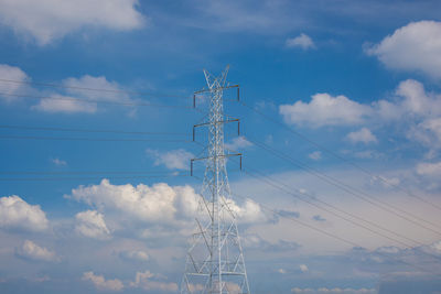 Low angle view of electricity pylon against sky