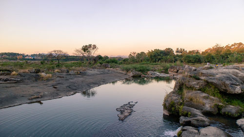 Scenic view of rocks against sky during sunset