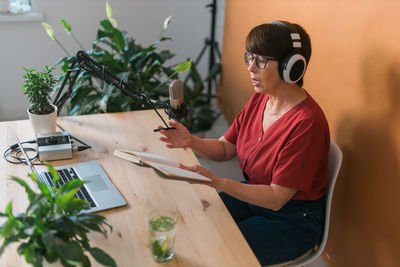 Senior woman podcasting at studio