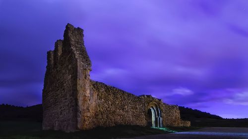 Castle on mountain against sky at night