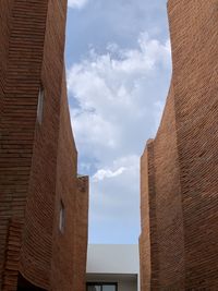 Low angle view of building against cloudy sky