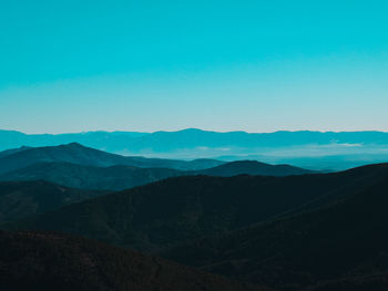 Scenic view of mountains against clear blue sky