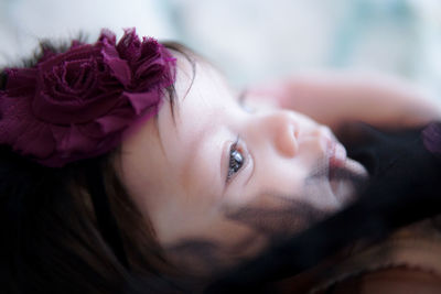 Profile view of baby girl lying on bed