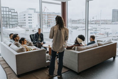 Businesswoman discussing strategy with male and female colleagues in conference meeting