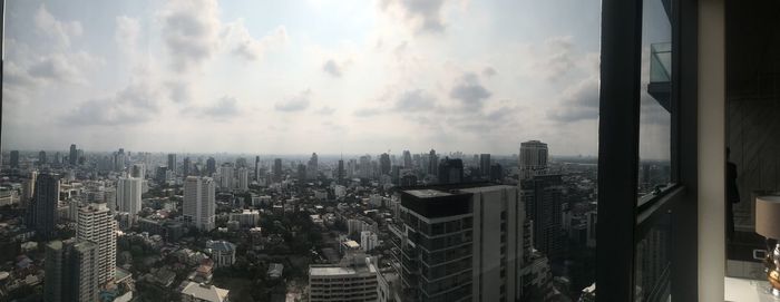 Panoramic view of modern buildings in city against sky