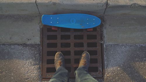 Low section of man standing on tiled floor