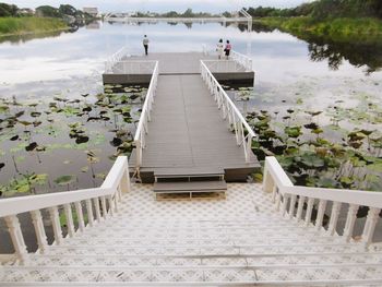 Scenic view of lake and jetty against sky