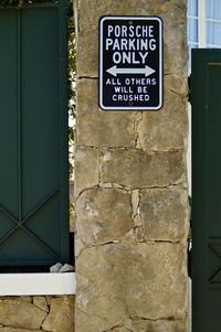 Close-up of parking signboard on wall