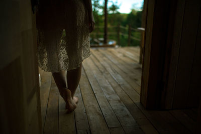 Low section of woman standing in doorway