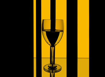 Close-up of yellow glass against black background