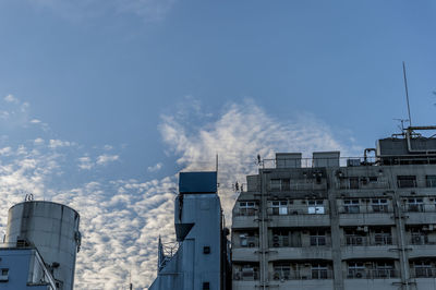 Low angle view of buildings against blue sky