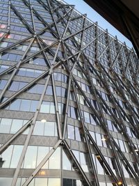 Low angle view of glass building against sky