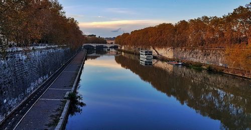 River tevere in rome reflecting the sky at sunset 