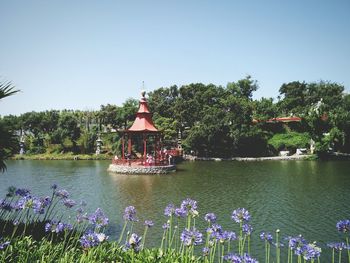 Gazebo in lake by buddha eden garden against clear sky