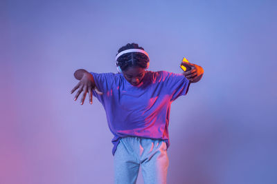 Low angle view of man standing against blue background