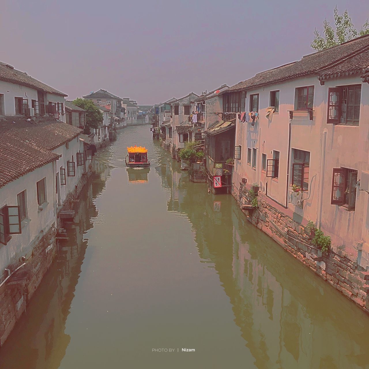 CANAL AMIDST BUILDINGS IN CITY