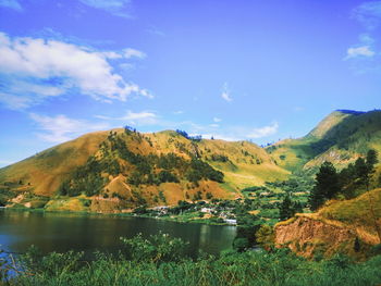 Scenic view of lake and mountains against sky