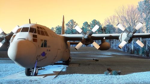 View of airplane on airport runway against sky