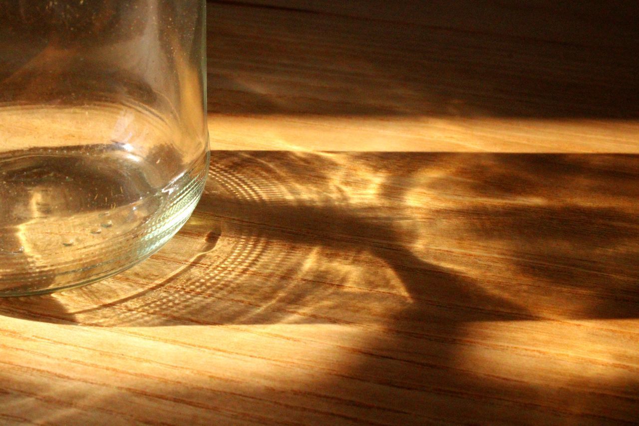 VIEW OF GLASS ON WOODEN TABLE