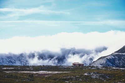 Scenic view of mountains against cloudy sky