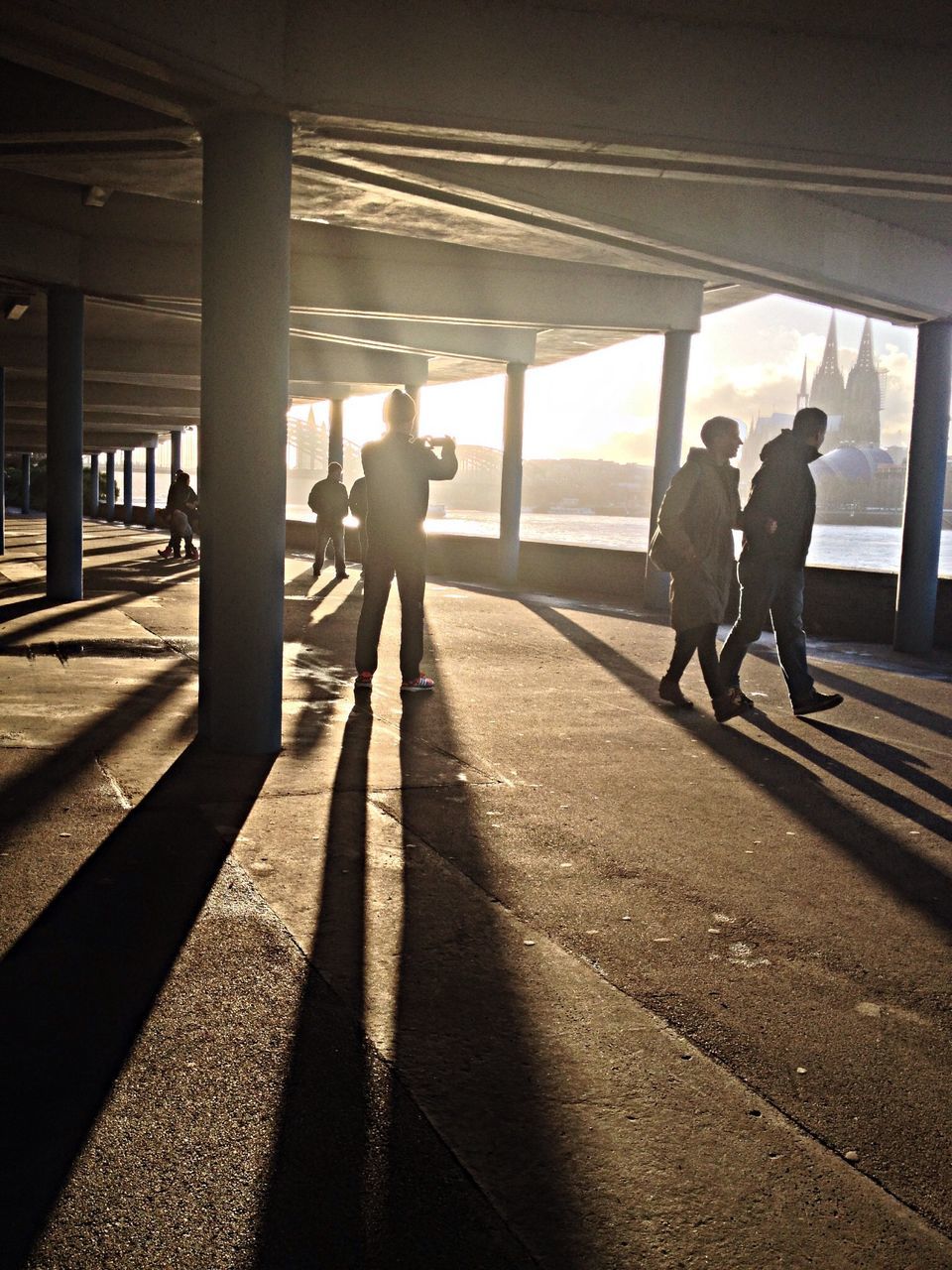 silhouette, walking, men, lifestyles, indoors, person, shadow, transportation, full length, sunlight, rear view, leisure activity, the way forward, standing, built structure, architecture, railroad station platform, travel