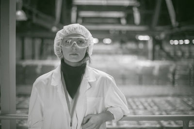 Female doctor wearing protective eyewear while working at hospital