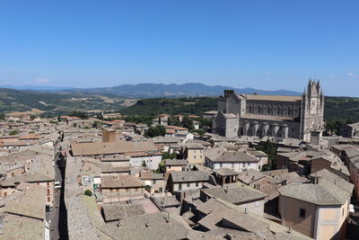 Aerial view of townscape against clear blue sky