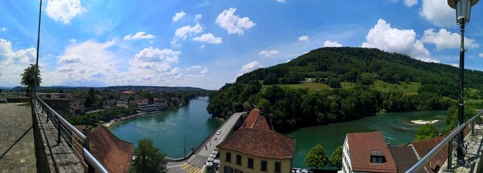 Panoramic view of buildings and trees against sky