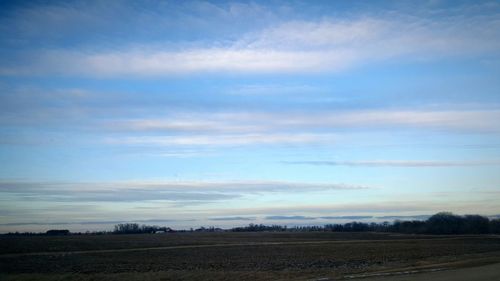 Scenic view of landscape against cloudy sky