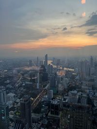 High angle view of illuminated cityscape against sky at night