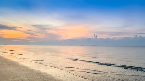 Scenic view of beach against sky during sunset