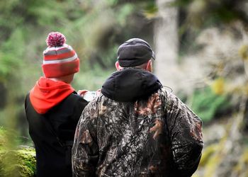 Rear view of two men outdoors