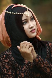 Thoughtful beautiful woman in hijab looking away