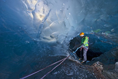 Woman exploring icecave on svinafellsjokull glacier