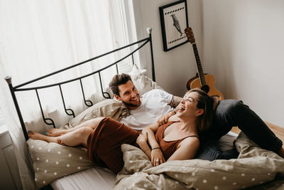 Young couple lying on bed at home