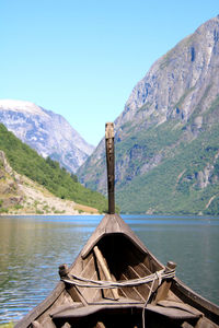 Scenic view of viking ship and fjord against mountain range