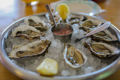 Close-up of oysters in plate on table