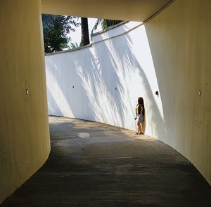 Rear view of man walking on wall