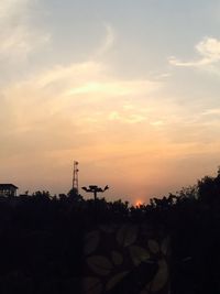 Silhouette trees against sky during sunset