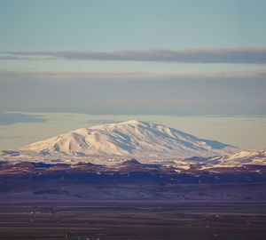 Scenic view of snowcapped mountains against sky during sunset