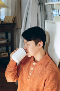 Boy drinking coffee at home