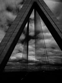 Low angle view of suspension bridge against sky