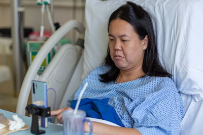 View of woman resting on bed at hospital