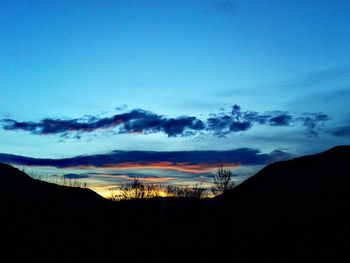 Silhouette of landscape against sky at sunset