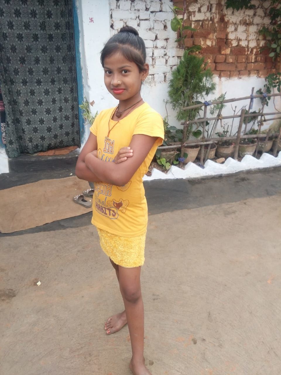 one person, yellow, childhood, child, standing, full length, portrait, looking at camera, casual clothing, women, architecture, day, lifestyles, clothing, leisure activity, female, person, human leg, smiling, front view, outdoors, innocence, limb, emotion, built structure, fashion, nature, spring, happiness, human face