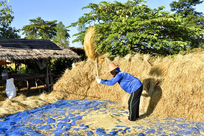 Side view of woman standing on field